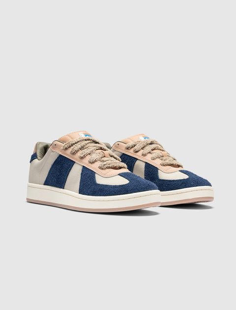 Men's low-top sneakers with blue suede panels, beige accents, and textured laces on white sole