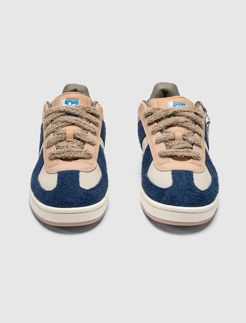 Men's blue and beige textured sneakers with suede details and thick tan laces, front view