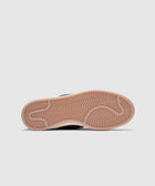 Gum outsole of a low-top sneaker with herringbone tread pattern on white background