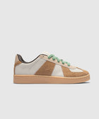 Low top sneaker with cream and brown suede panels, green textured laces, gum sole on white background