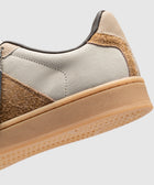 Close-up of men's streetwear sneaker in beige, cream, and brown with textured sole