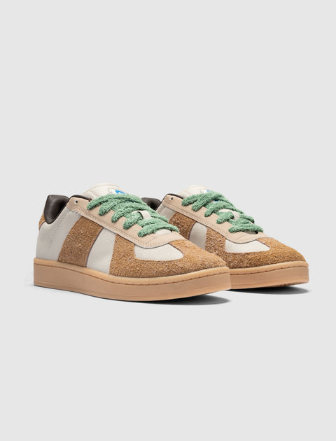 Men's streetwear sneakers with brown suede panels, cream accents, and green laces