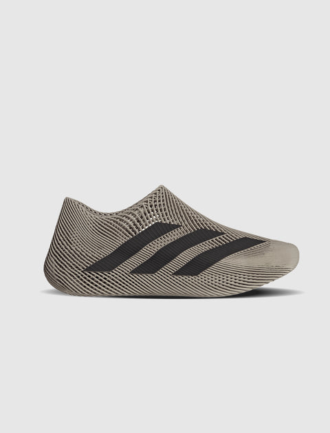 Beige mesh slip-on sneaker with black stripes and sculpted futuristic design side view