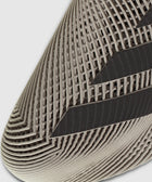 Close-up of beige sneaker toe with geometric mesh pattern and black stripes