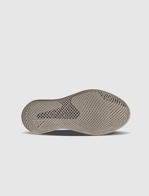 Beige sneaker sole with textured, ventilated pattern on light background