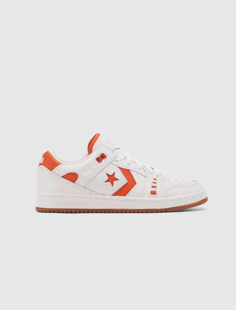 White and orange low-top sneaker with leather upper, side star detail, and gum sole on plain background
