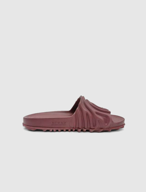 Maroon sculpted slide sandal with textured upper and rugged sole on white background
