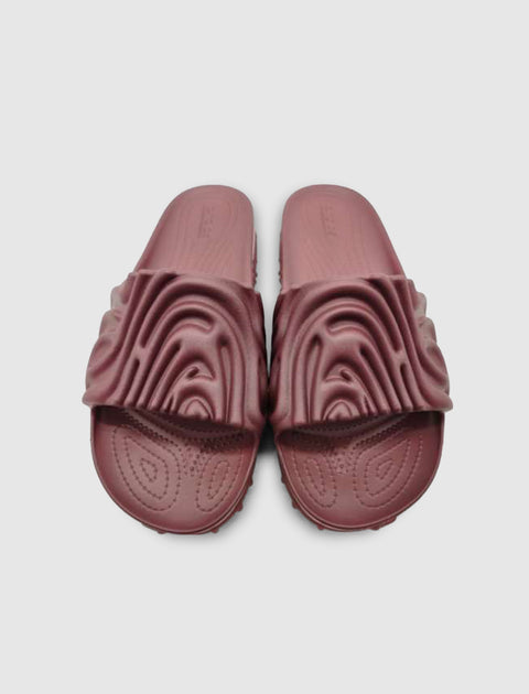 Pair of textured maroon slide sandals with sculpted top strap on plain background
