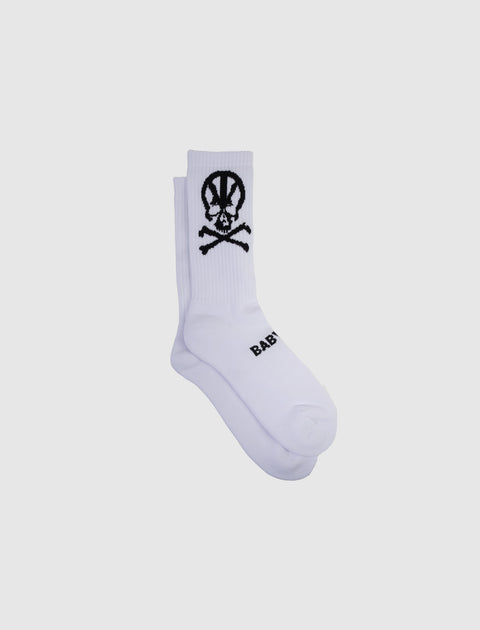 White crew socks with black skull and crossbones graphic and text design on the side