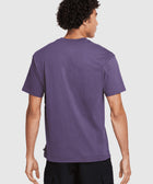 Back view of man wearing a purple short sleeve streetwear t-shirt and black cargo pants