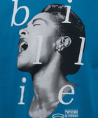 Blue streetwear top with large black and white graphic of a singing woman and the word 'billie'.