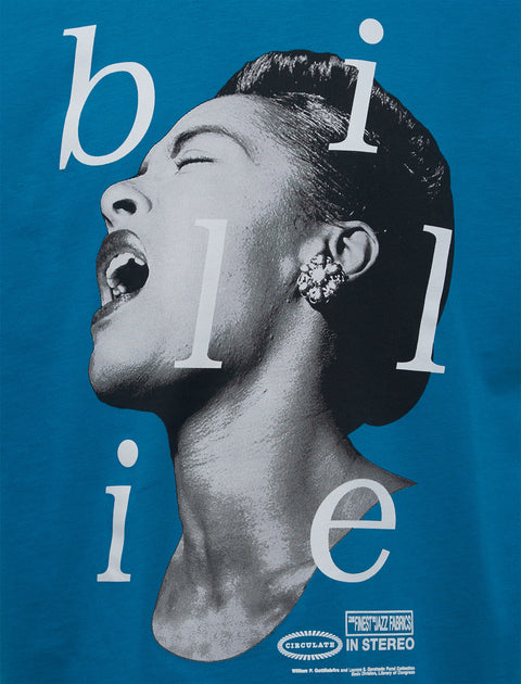 Blue streetwear top with large black and white graphic of a singing woman and the word 'billie'.