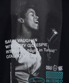 Black streetwear shirt featuring a grayscale singer print and bold retro album text graphics