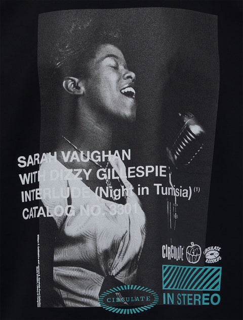 Black streetwear shirt featuring a grayscale singer print and bold retro album text graphics
