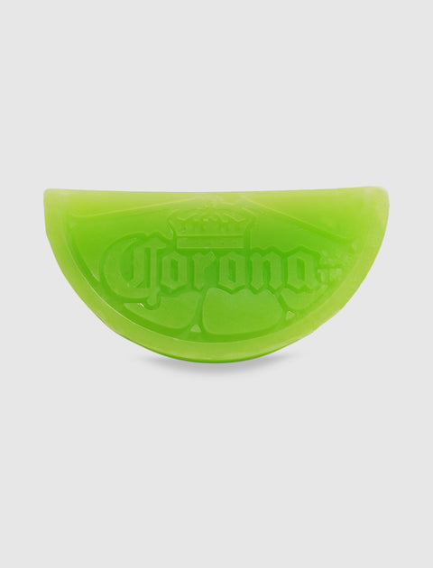 Green lime wedge-shaped soap bar with embossed logo on a white background