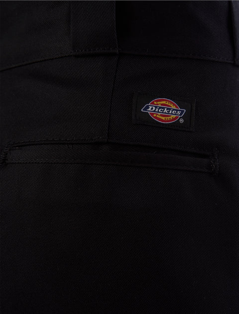 Close-up of black men's pants pocket with Dickies logo patch detail