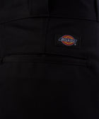 Close-up of back pocket on black men's Dickies pants with logo patch