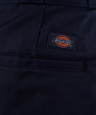 Close-up of navy men's streetwear pants pocket with logo patch detail