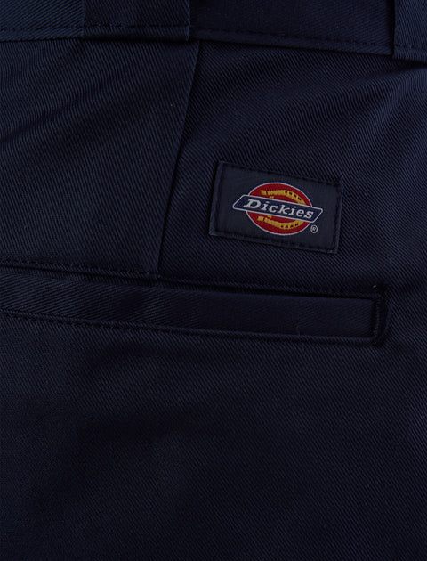 Close-up of navy men's streetwear pants pocket with logo patch detail