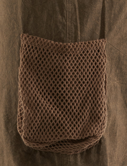 Close-up of brown mesh pocket on khaki streetwear apparel