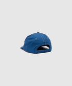 Back of a blue adjustable snapback cap on a plain background, streetwear accessory