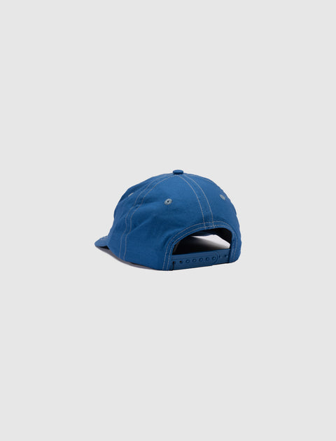 Back of a blue adjustable snapback cap on a plain background, streetwear accessory