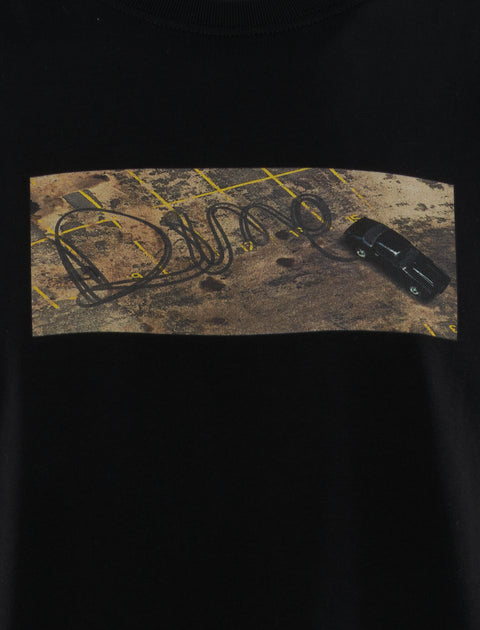 Black streetwear t-shirt with car skid mark graphic in parking lot forming Dime logo