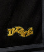 Black mesh fabric with yellow embroidered patch and grey trim, streetwear detail