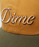 Closeup of brown and green cap with gold embroidered "Dime" logo, streetwear accessory