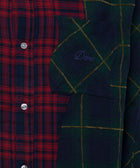 Close-up of a men's plaid button-up shirt with red and green checkered panels and Dime embroidery on the pocket.