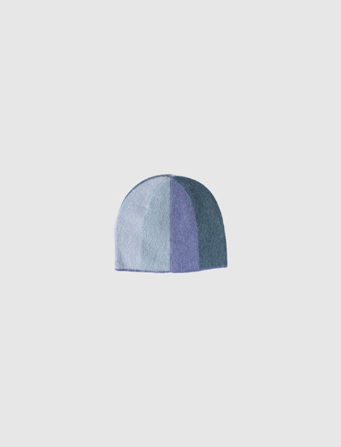 Blue patchwork knit beanie hat with panel design on white background