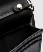 Close-up of black leather wallet with silver snap and stitched details