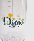 Clear water bottle with measuring marks, floral dandelion design, and 'Dime PLEIN-AIR' text.