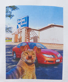 Graphic print t-shirt featuring a surreal cat-dog hybrid, red car, and bowling alley