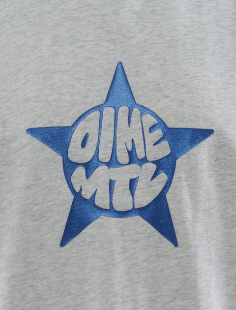 Close-up of grey streetwear tee with metallic blue star and bold graphic text print