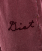 Close-up of maroon fabric with embroidered 'Diet' script, men's streetwear detail