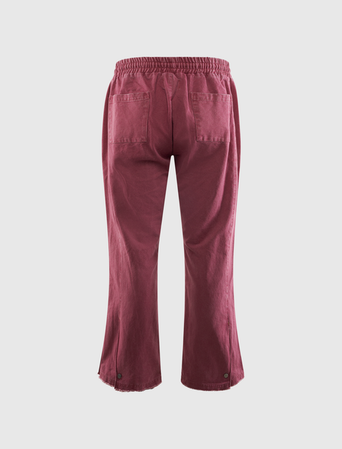 Back view of maroon men's streetwear pants with elastic waistband and patch pockets