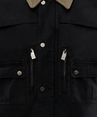 Black streetwear jacket with beige corduroy collar, front snap buttons, chest pockets, and zippers