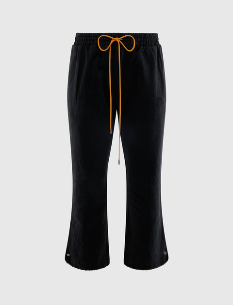 Men's black cropped streetwear pants with yellow drawstring and wide leg silhouette