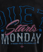 Close-up of black streetwear shirt with bold text Diet Starts Monday and stars graphic.