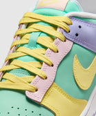 Close-up of pastel multicolor low-top sneaker with yellow laces and Nike swoosh logo