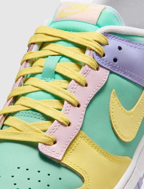 Close-up of pastel multicolor low-top sneaker with yellow laces and Nike swoosh logo