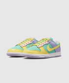 Pastel multicolor low-top sneakers with yellow, green, and purple accents on a white sole
