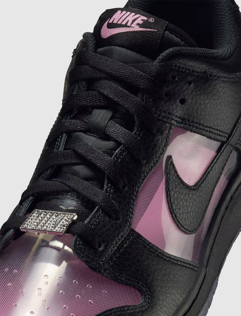 Close-up of black and pink Nike sneaker with textured leather and translucent panels
