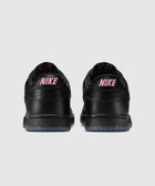 Back view of black low-top sneakers with pink NIKE branding and translucent soles