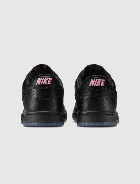 Back view of black low-top sneakers with pink NIKE branding and translucent soles