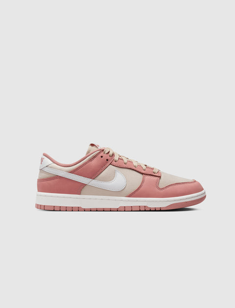 Low-top sneaker with pink and beige panels, white swoosh logo, and white sole on plain background