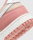 Close-up of a pink and beige sneaker heel with white sole and visible textured outsole.