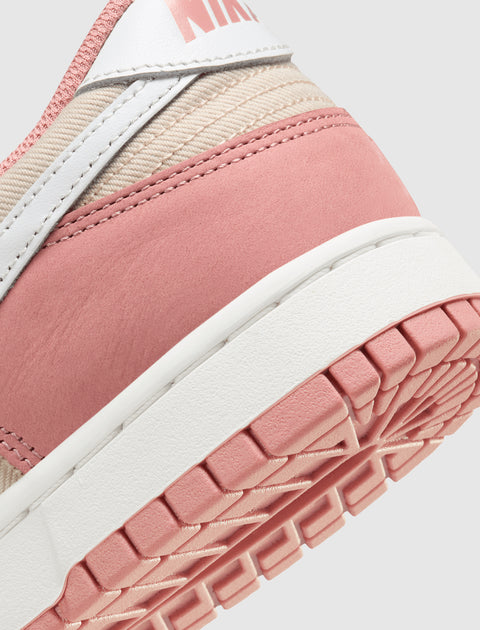 Close-up of a pink and beige sneaker heel with white sole and visible textured outsole.