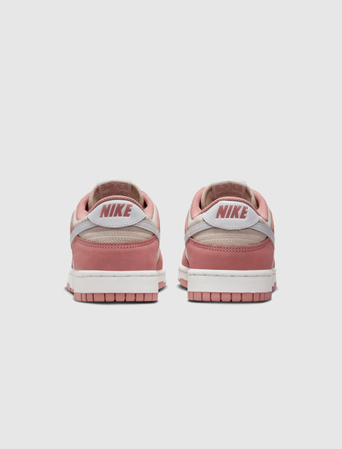 Back view of pink and white Nike Dunk Low sneakers on a white background